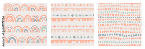 Set of kids boho seamless patterns with rainbow, stripes and dots in doodle style in a natural color palette. Pastel naive nursery print design on a light background. Trendy contemporary kids backdrop