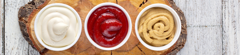 banner of Set of kinds of classic sauces on wooden board with knife and fork. Mayonnaise ketchup mustard banner of Set of kinds of classic sauces on wooden board with knife and fork. Mayonnaise ketchup mustard