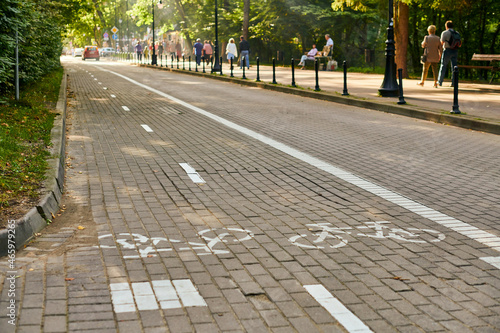 Two way cycle path and traffic car, white painted bicycle sign on road. Healthy lifestyle, ecology photo