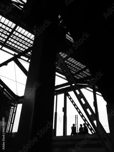 people and Steel beam silhouettes have white sky background