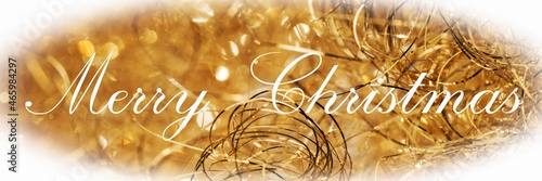 Merry Christmas, lettering on golden sparkling background with white vignette. Panorama