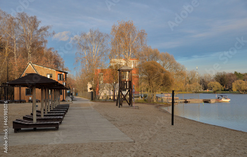 Beach on shore of Meshchersky pond in Meshchersky natural park (Bakovsky forest park) in autumn, Odintsovsky district of Moscow region and Moscow, Russia photo