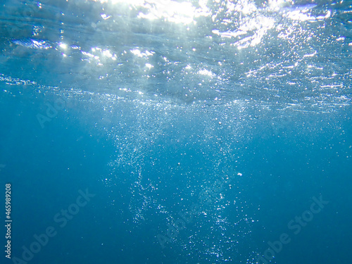 Bubbles under the sea in the crystal clear green sea water. Mediterranean sea bubbles. Real image very suitable for backgrounds, Air bubbles underwater rising to water surface, natural scene.