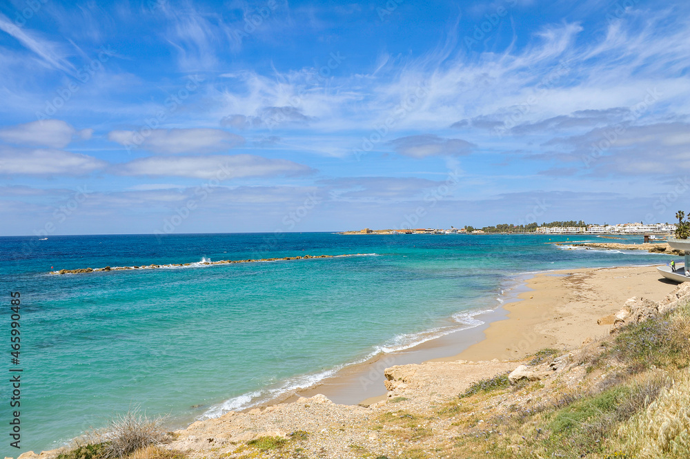 The charm of the spring coast of Paphos consists of the bright color of the sea, bizarre coastal rocks and a scattering of large and small blooming plants    