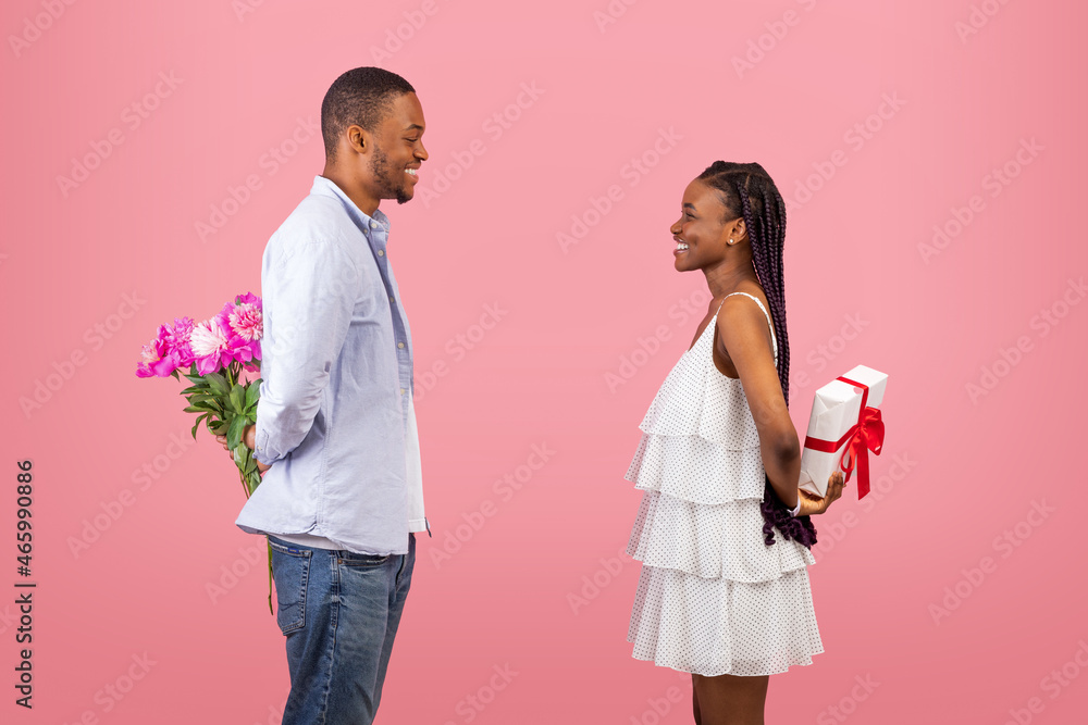 Happy black couple making surprise for each other Happy black couple making surprise for each other
