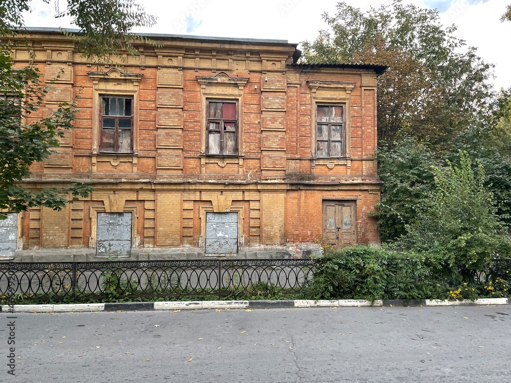Facade of architectural abandoned building. Neglected historic house in city. Facade of architectural abandoned building. Neglected historic house in city.