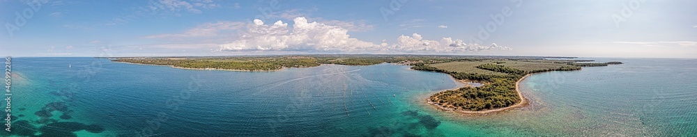 Drone panorama over the Istrian Adriatic coast near Porec with Porto Busola peninsula during the day