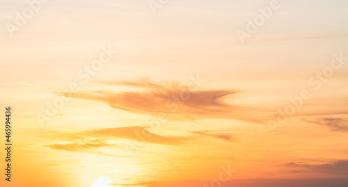 Sunset sky clouds in the evening on golden hour with orange sunlight sky background 