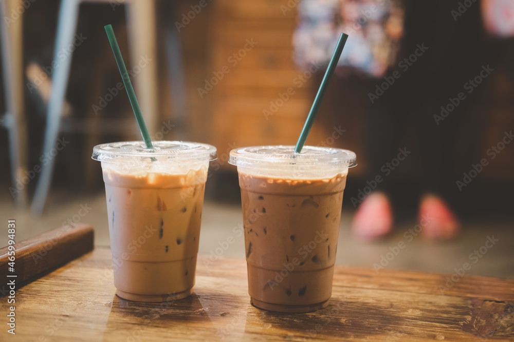 Two plastic take away cups of iced coffee mocha and iced coffee