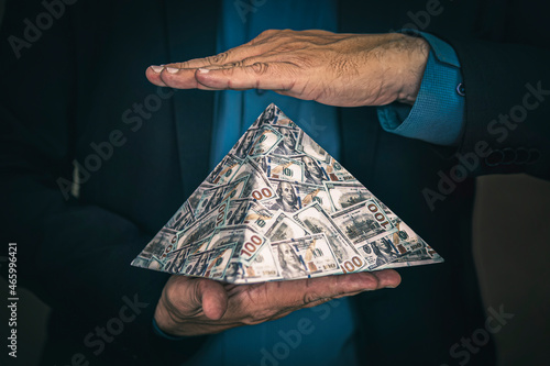 pyramid scheme in the hands of a fraudster. The concept of exchange in financial markets is the collapse of the financial system of capitalism. photo