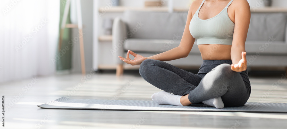 Cropped Shot Of Young Woman Meditating In Lotus Position At Home Cropped Shot Of Young Woman Meditating In Lotus Position At Home
