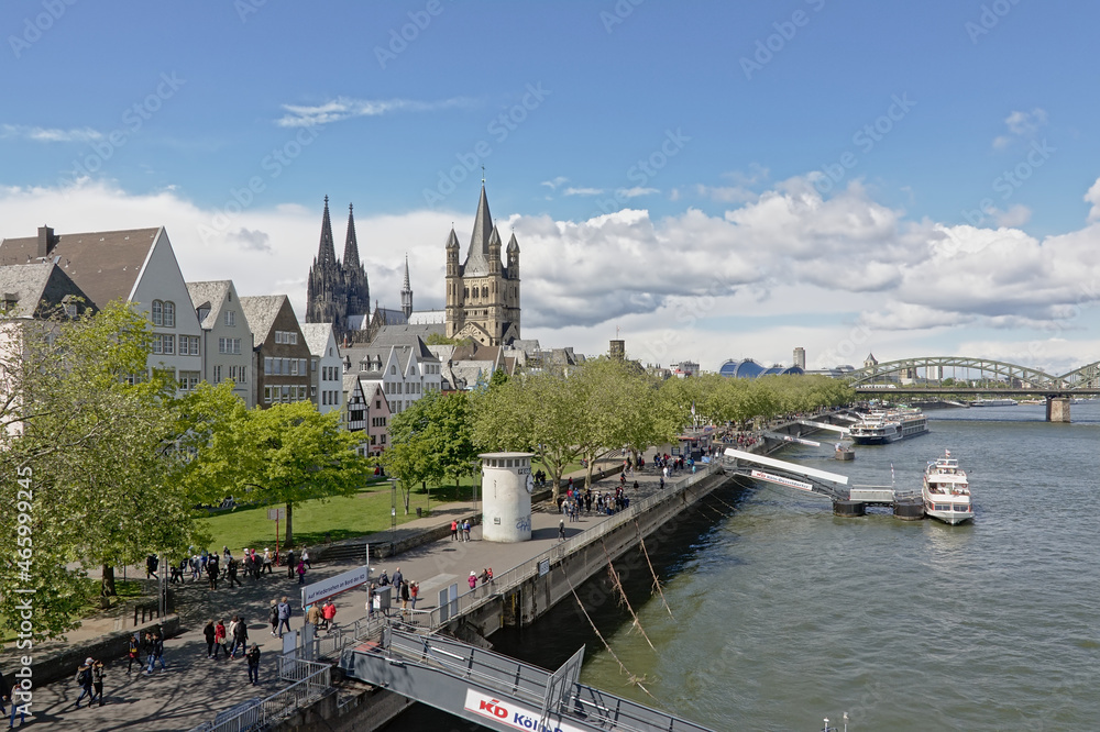 Towers of Cologne cathedral, and great saint Martin church and medieval houses on the embankment of river Rhine, Cologne, Germany