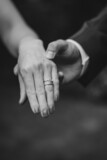 Black and white photo of bride and groom with wedding ring.