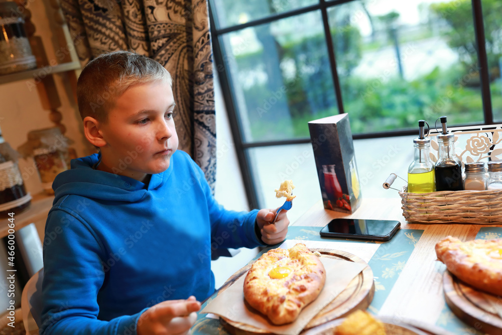 Child eating Adjarian khachapuri Child eating Adjarian khachapuri