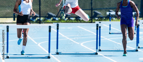 High school girls racing in the 400 meter hurdles © coachwood