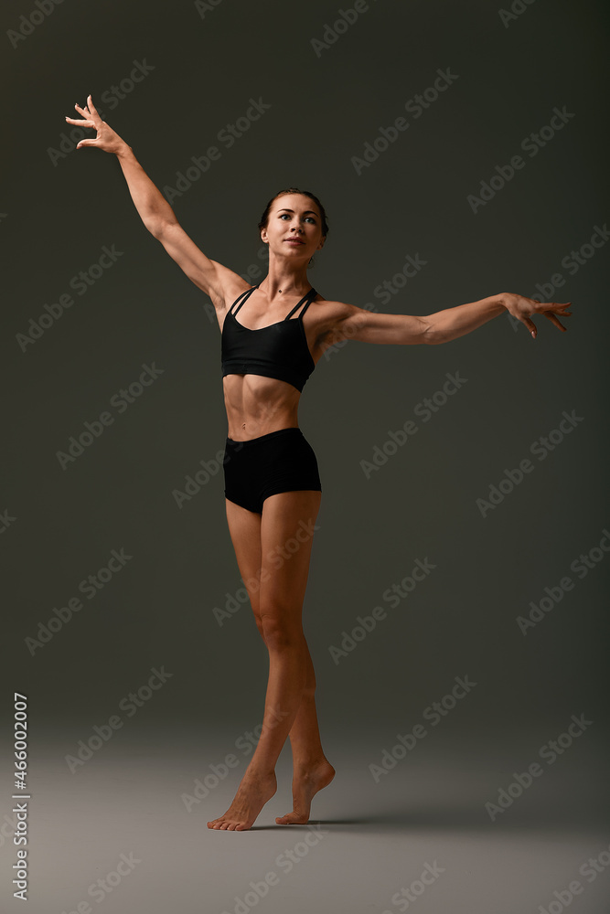 Emotional Female Ballet Dancer in Body Suit and Posing in Dance in Various Poses Against Gray Background