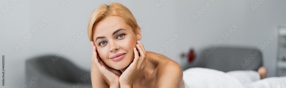 happy blonde client looking at camera in spa center, banner happy blonde client looking at camera in spa center, banner