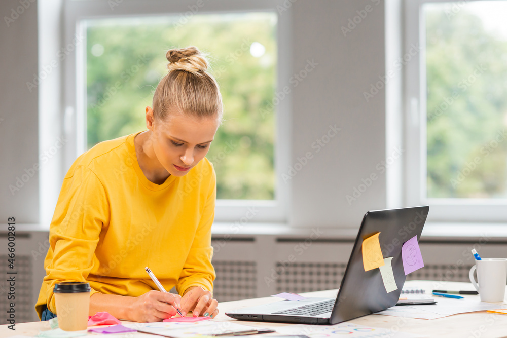 Workplace of freelance worker or a student girl at home office. Young woman works using computer and other devices. Remote job concept. Workplace of freelance worker or a student girl at home office. Young woman works using computer and other devices. Remote job concept.