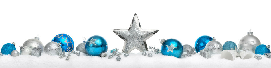 Christmas decoration border with stars and baubles in silver and blue arranged in a row on snow, isolated on white background 