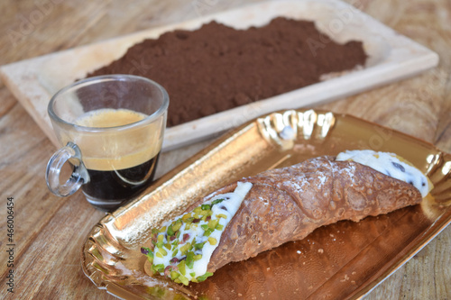 espresso coffee  with a cannolo and gound coffee photo