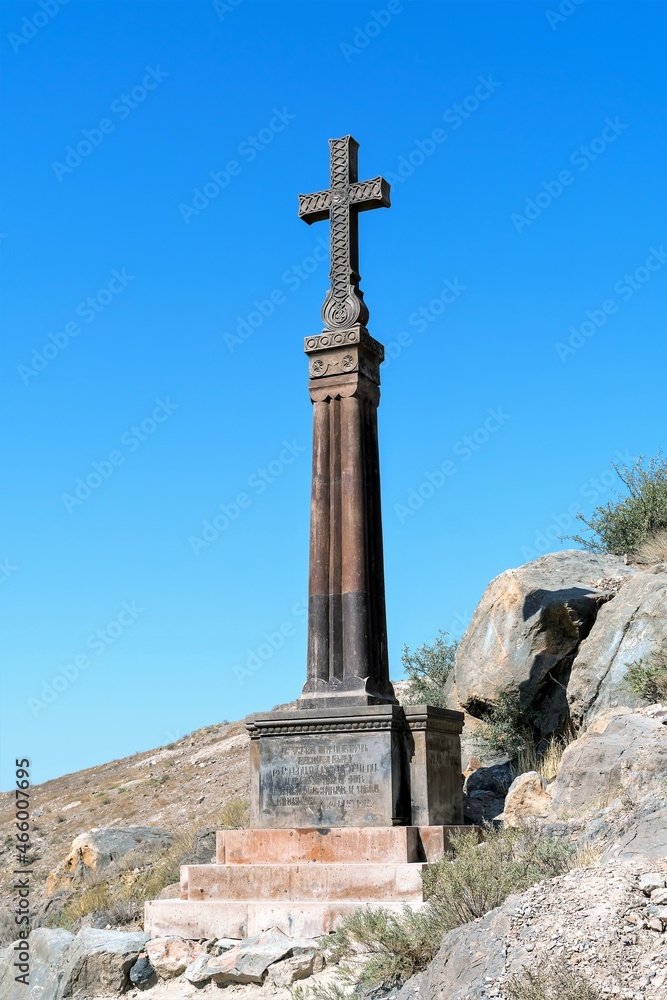 Armenia, Khor Virap, September 2021. An ancient stone monument with a cross at the walls of the monastery.