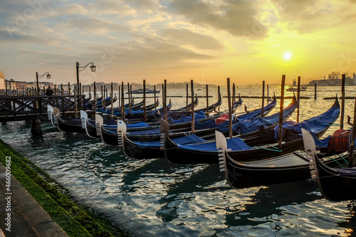 Gondolas on the jetty of San Marco square in Venice at sunset