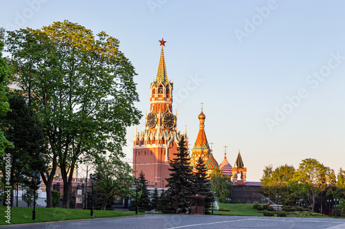 Fototapeta Naklejka Na Ścianę i Meble -  Summer sunny evening on the territory of the Moscow Kremlin. The Spasskaya Tower of the Moscow Kremlin in the rays of the setting sun.