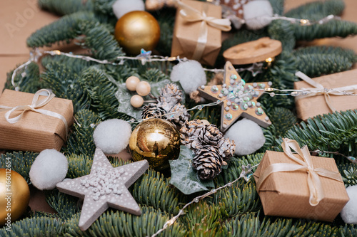 Fir branches with christmas decorations and gifts on kraft paper background