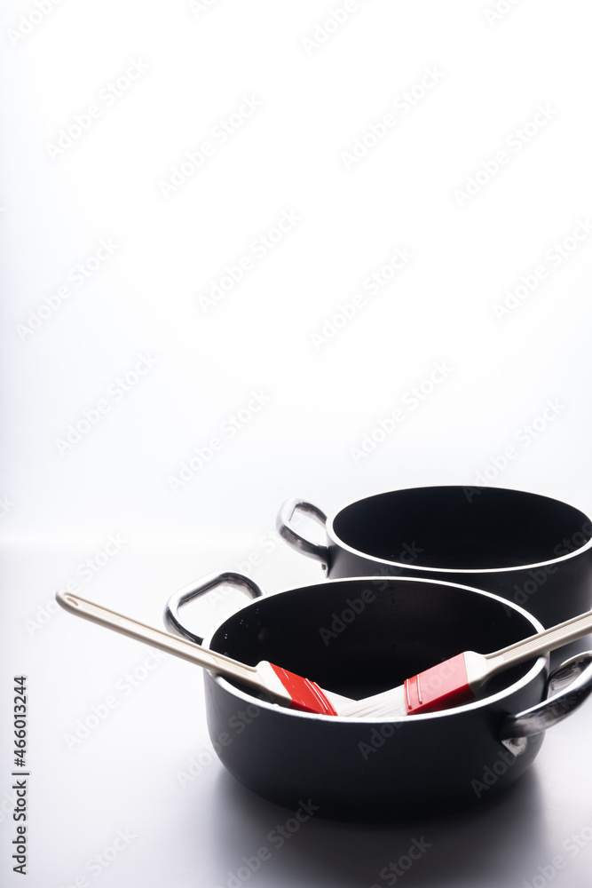 frying pans with food brushes on white background frying pans with food brushes on white background