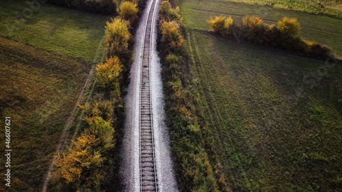 Aerial view of the railway that passes through beautiful autumn landscapes
