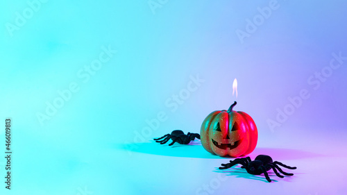 Happy halloween. Black night spider, scary spooky pumpkin on night neon helloween background. Happy Halloween concept. Frame. Copy space. photo