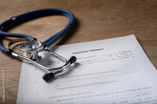 Medical insurance, contract and stethoscope for health insured.