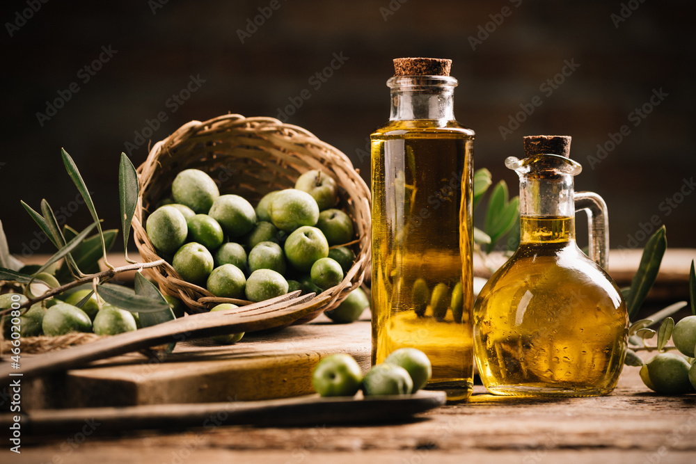Olive oil with fresh olives on rustic wood - obrazy, fototapety, plakaty 