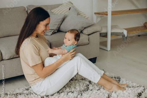 Mother with her little baby girl at home photo