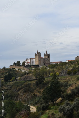A beautiful church and some trees in a town Miranda Do Douro in Portugal