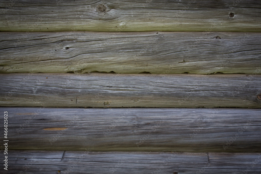 Wooden logs of an old house. Close-up. Weathered natural gray wood texture. Background. Horizontal photo Wooden logs of an old house. Close-up. Weathered natural gray wood texture. Background. Horizontal photo