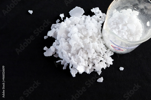 Potassium hydroxide flake on black background photo
