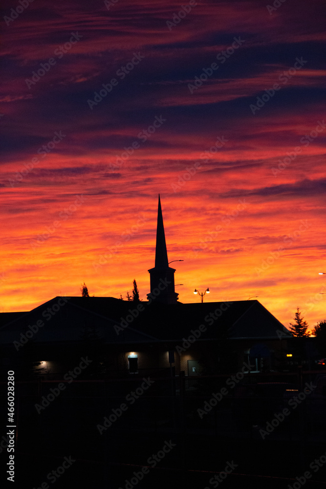 Obraz premium Silhouette of a church at sunrise, Sunrise in the neighbourhood, Calgary cityscape