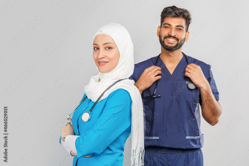 professional muslim doctor woman and indian assistant discuss tasks. portrait of beautiful medical workers with stethoscopes professional muslim doctor woman and indian assistant discuss tasks. portrait of beautiful medical workers with stethoscopes