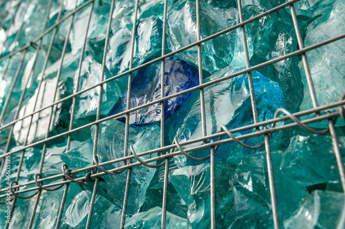 Decorative gabion construction filled with glass waste photo