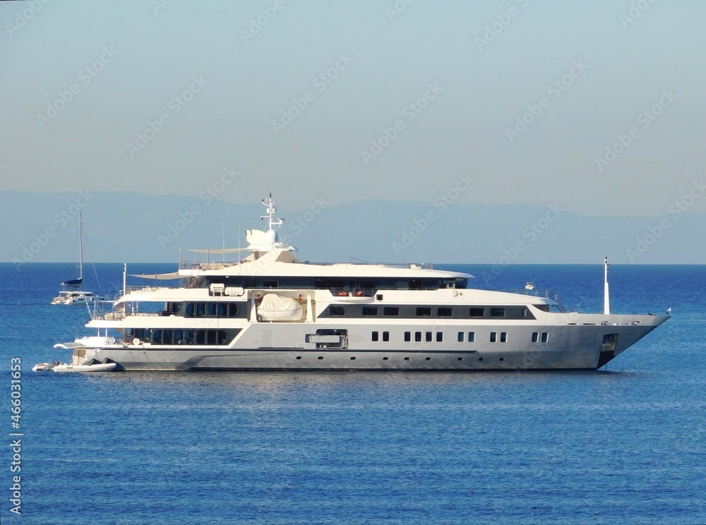 A luxury yacht near the coast of Vouliagmeni in Attica, Greece A luxury yacht near the coast of Vouliagmeni in Attica, Greece