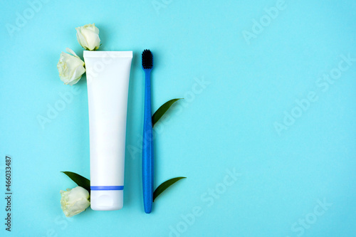 Wallpaper Mural Recycled plastic toothpaste tube with toothbrush with white flowers and foliage on a light blue background. Freshness and hygiene concept. Conscious consumption. Copy space Torontodigital.ca