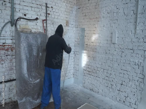 painter spray gun paint the wall