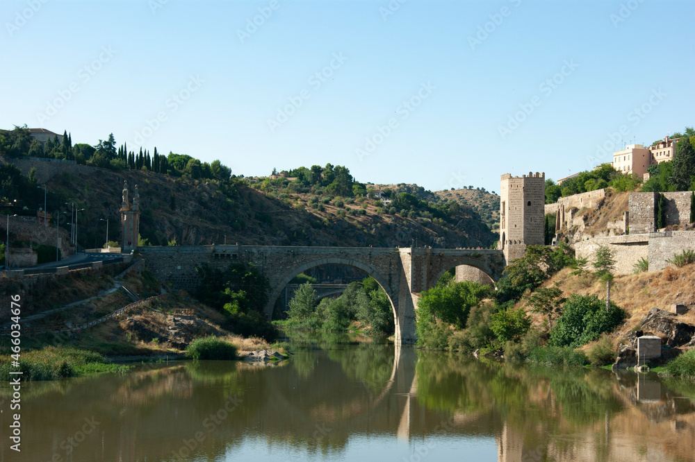 Elegant Alcantara bridge at the beautiful historic Spanish city of Toledo. Landscape aspect view of this ancient monument.