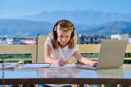 Girl child 10, 11 years old studying at home online
