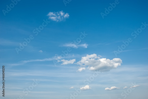 Blue sky background with tiny clouds.