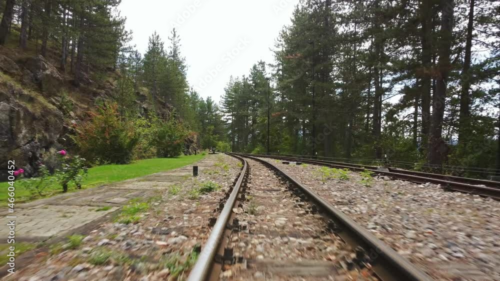 Front view of a moving train on old railway with slight moving to the sides.	
