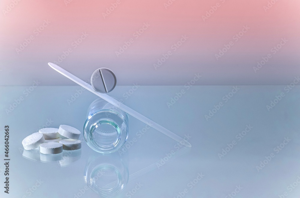 The pill rolls down a make-up slide of swings on an empty jar upside down. The pill rolls down a make-up slide of swings on an empty jar upside down.