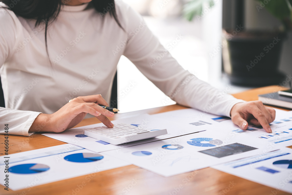 businessman or accountant who are using a calculator to calculate business data Accounting documents and laptop computer at the office business idea businessman or accountant who are using a calculator to calculate business data Accounting documents and laptop computer at the office business idea