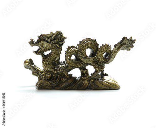 figurine of a dragon holding a pearl in its paw on white background
